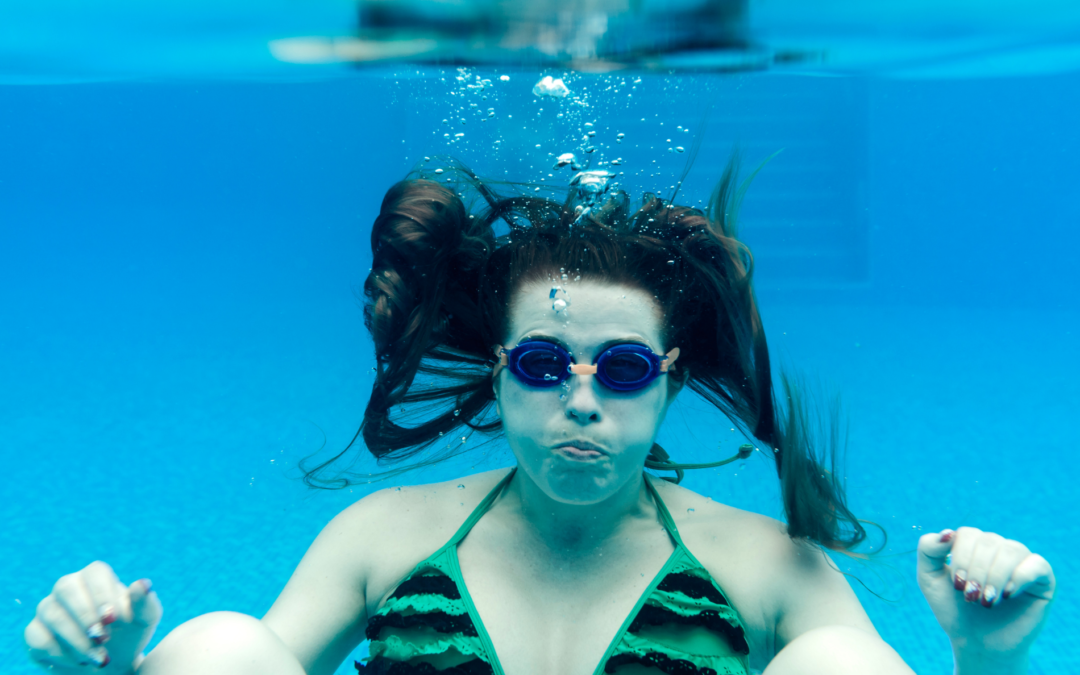 Woman under water holding her breath